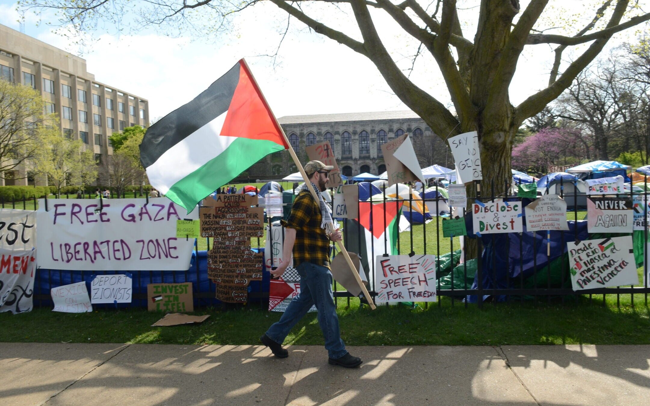 Banners hanging from the fence outside Northwestern University during a pro-Palestinian protest, Evanston, Illinois, April 27, 2024. 