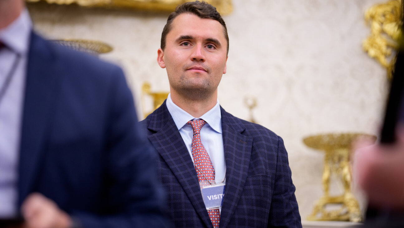 Turning Point USA co-founder Charlie Kirk stands in the back of the room as U.S. President Donald Trump speaks during a swearing in ceremony for interim U.S. Attorney for Washington, D.C. Jeanine Pirro in the Oval Office of the White House on May 28, 2025 in Washington, DC.