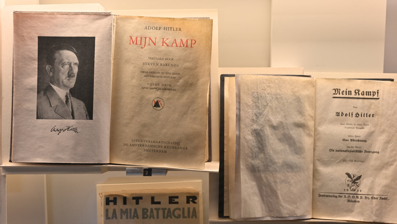Adolf Hitler's "Mein Kampf," accompanied by his portrait, at the Shoah Memorial in Paris, France, on August 6, 2025.
