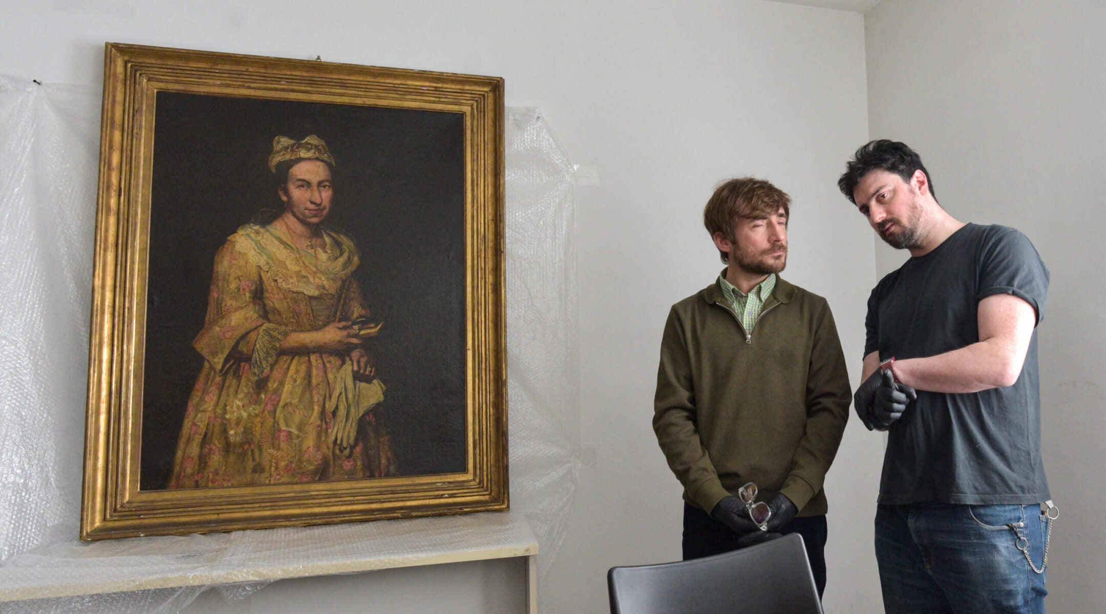 Visual arts teacher Ariel Bassano (L) stands next to a painting identified by Dutch newspaper AD as believed to be “Portrait of a Lady” by Italian baroque portraitist Giuseppe Ghislandi, stolen by the Nazis from a Dutch Jewish art collector, as it is displayed at the Public Prosecutor’s Office in Mar del Plata, Argentina, on Sept. 3, 2025.