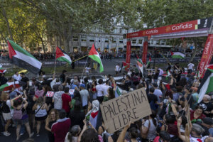 Pro-Palestinian protesters invade the circuit of La Vuelta race as one holds a placard reading 'Free Palestine' in the center of Madrid on Sept. 14