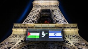 Images of the Palestinian (L) and Israeli (R) flag and a dove with an olive olive branch are projected onto the Eiffel Tower on the eve of France’s planned recognition of the State of Palestine, in Paris, on Sept. 21, 2025. 