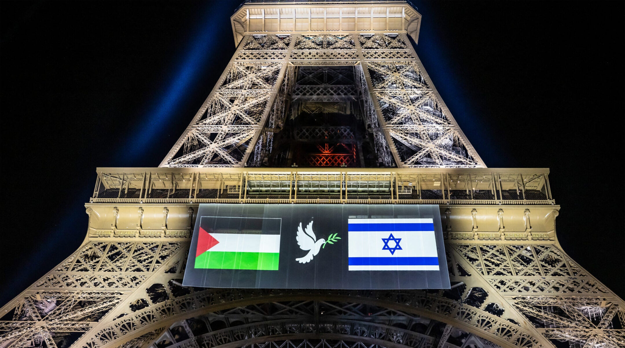 Images of the Palestinian (L) and Israeli (R) flag and a dove with an olive olive branch are projected onto the Eiffel Tower on the eve of France’s planned recognition of the State of Palestine, in Paris, on Sept. 21, 2025.