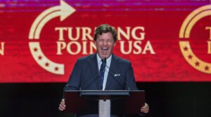 Political commentator Tucker Carlson speaks during the memorial service for political activist Charlie Kirk at State Farm Stadium on Sept. 21, 2025 in Glendale, Arizona. 