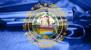 The New Hampshire flag is overlaid with a gun. 