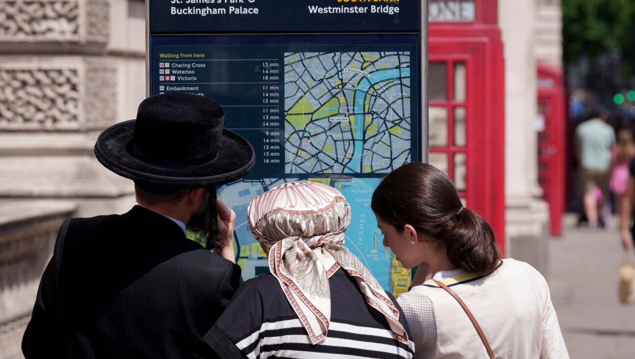 Hasidic Jews look at directions from a London street map in Westminster, on 18th June 2025, in Westminster, London, England.