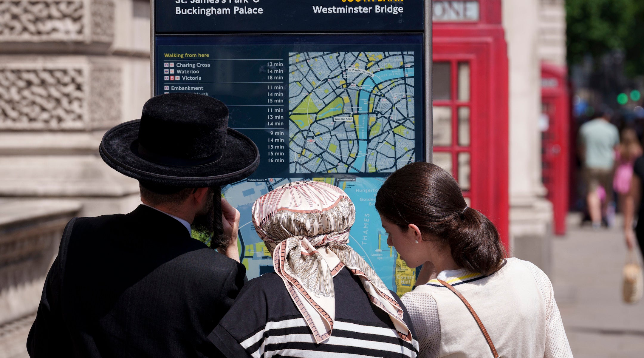 Hasidic Jews look at directions from a London street map in Westminster, on 18th June 2025, in Westminster, London, England.
