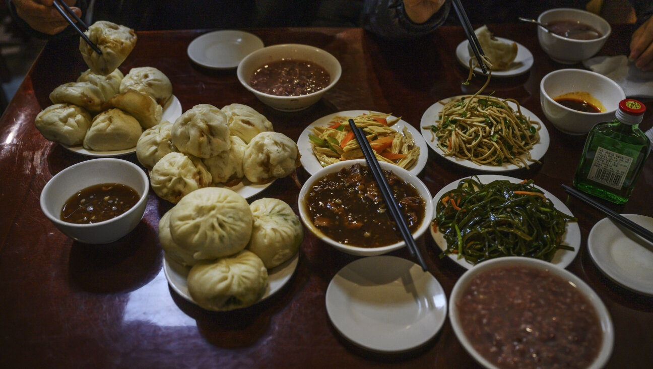 Dishes of steamed buns, stew and other items are seen on the table at local restaurant Yaoji Chao Gan in Beijing, China, Nov. 9, 2020. 