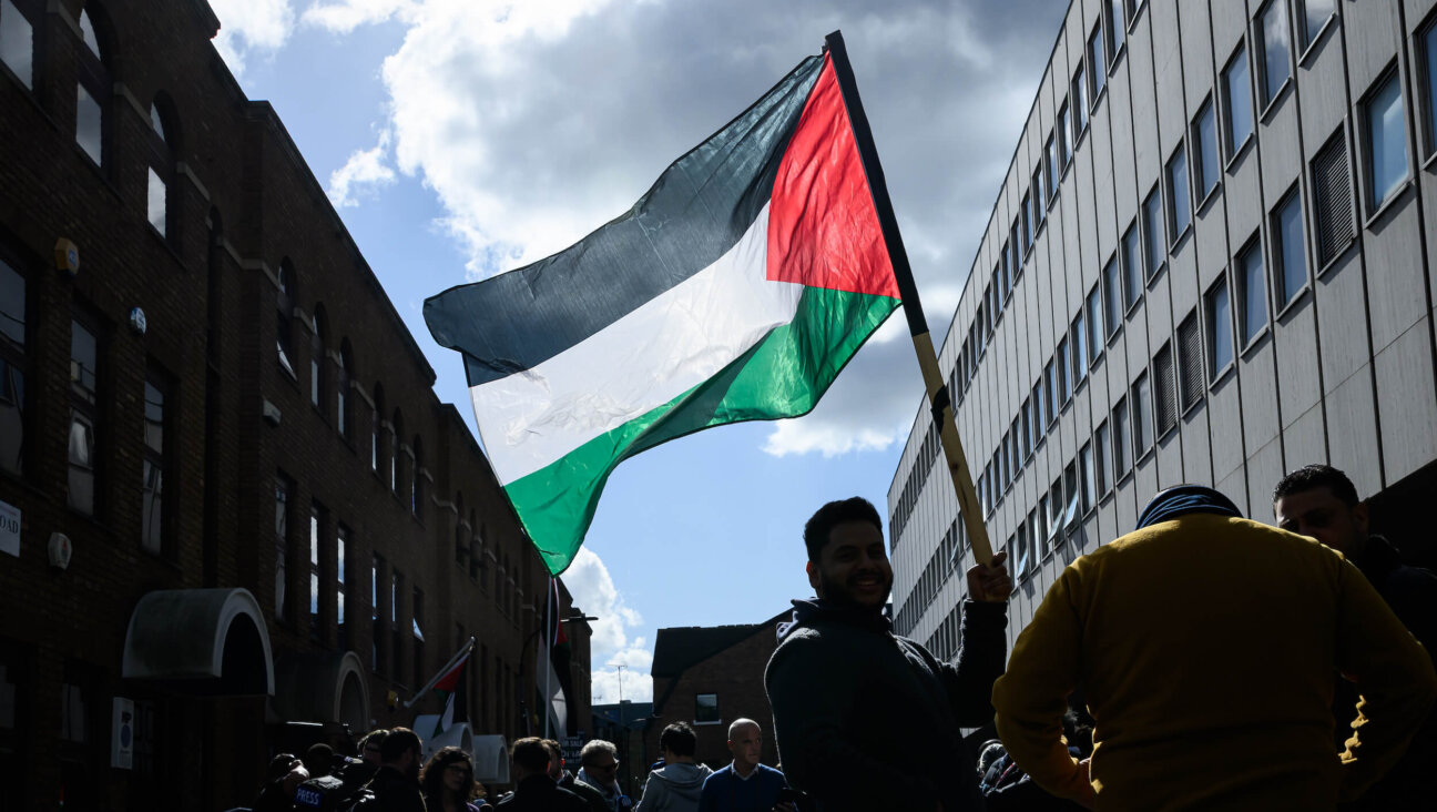 A man holds a Palestinian flag outside the Palestine Mission to the United Kingdom in London on Sept. 22.