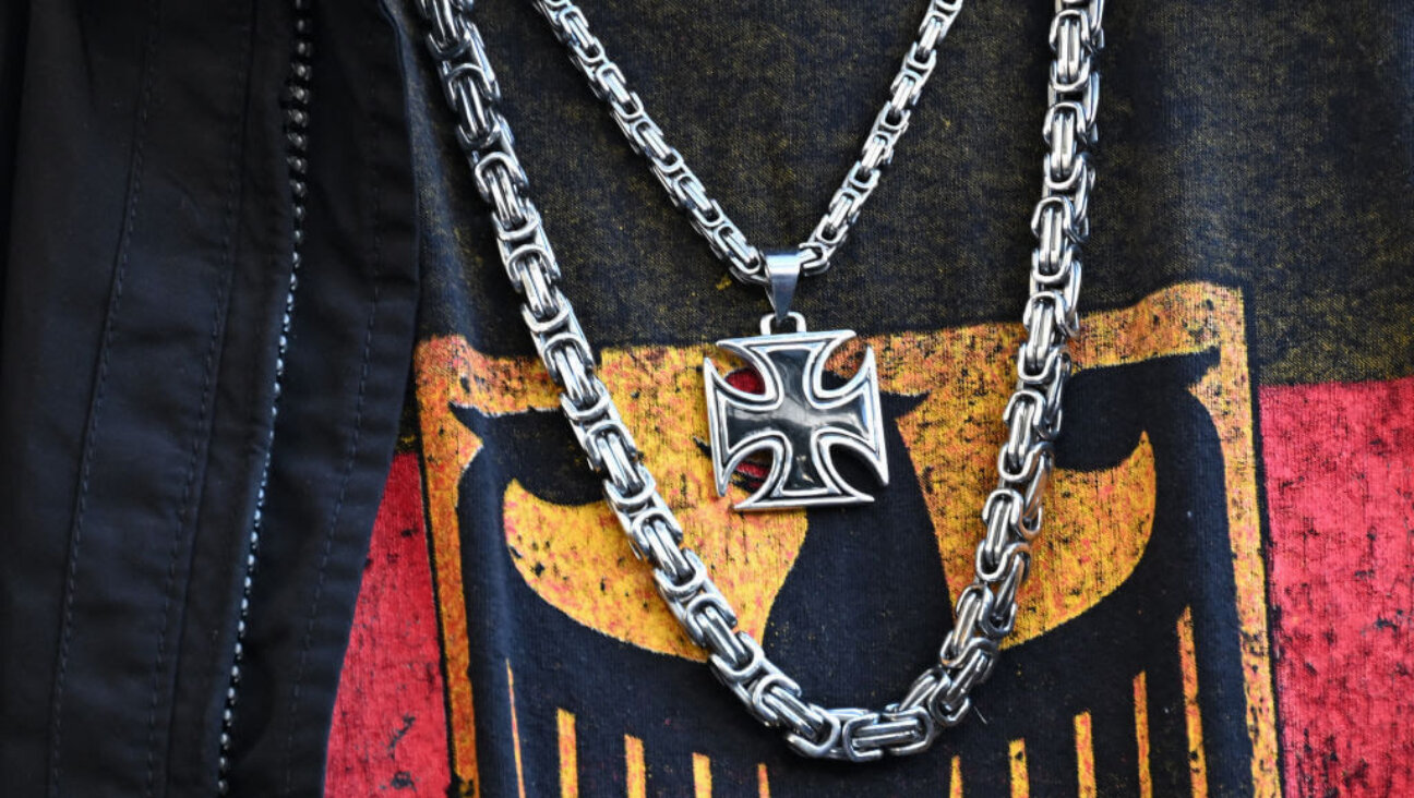A participant in a far-right demonstration, wearing a T-shirt with the federal eagle and an iron cross chain, is pictured in Berlin on March 22.