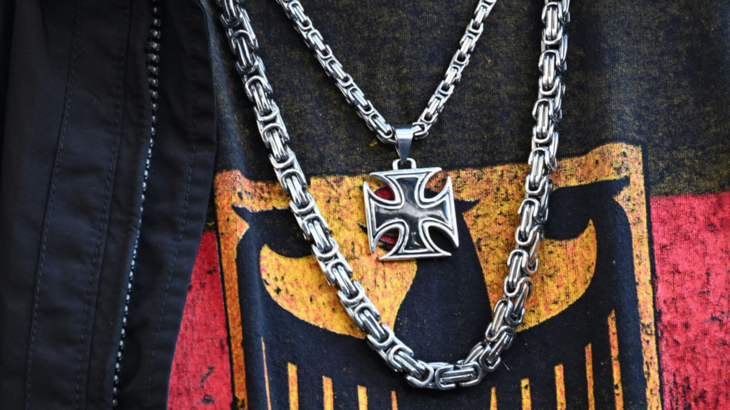 A participant in a far-right demonstration, wearing a T-shirt with the federal eagle and an iron cross chain, is pictured in Berlin on March 22.