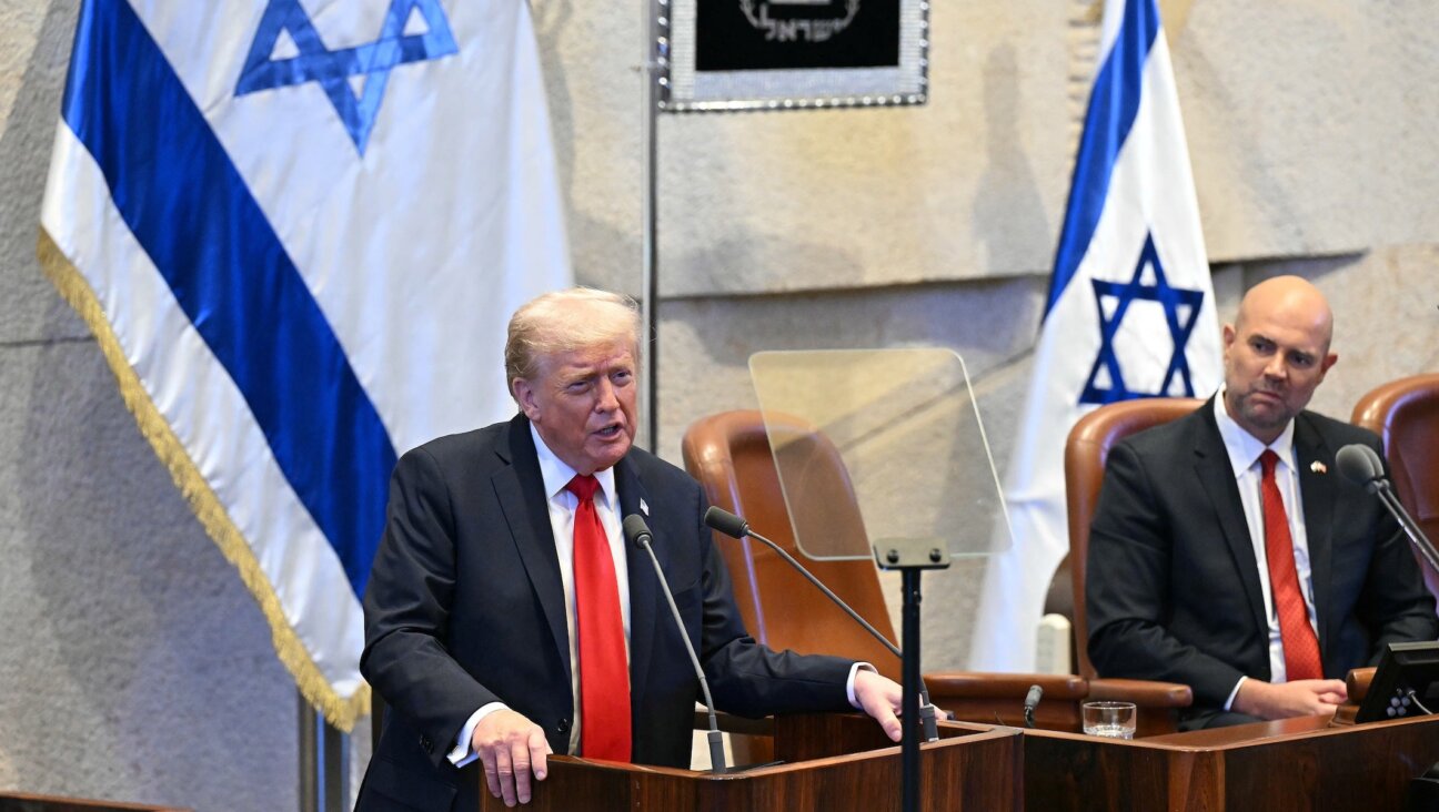U.S. President Donald Trump (L) addresses the Israeli parliament, the Knesset, on October 13, 2025 in Jerusalem. President Trump is visiting the country hours after Hamas released the remaining Israeli hostages captured on Oct. 7, 2023, part of a US-brokered ceasefire deal to end the war in Gaza. 