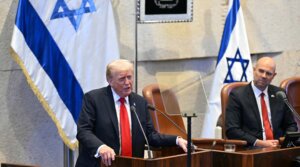 U.S. President Donald Trump (L) addresses the Israeli parliament, the Knesset, on October 13, 2025 in Jerusalem. President Trump is visiting the country hours after Hamas released the remaining Israeli hostages captured on Oct. 7, 2023, part of a US-brokered ceasefire deal to end the war in Gaza. 
