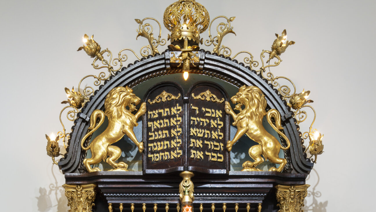 The top of Sam Katz's wooden Torah ark, featuring a pair of golden lions and a Torah crown
