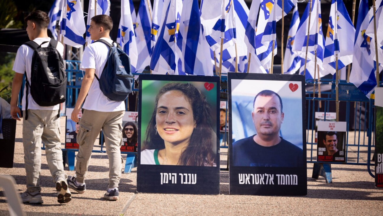 Posters of deceased hostages Inbar Hayman and Muhammad Al-Atarash stand in Hostage Squares in Tel Aviv after their release, Oct. 16, 2025. (Miriam Alster/Flash90)