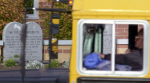 A school bus makes its way past a marker depicting the Ten Commandments outside of Peebles High School  in Ohio in 2002.