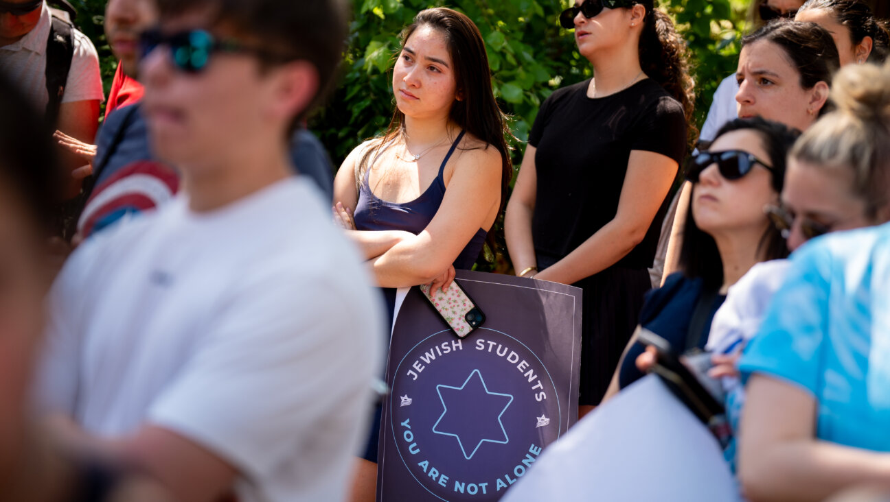 A woman holds a sign that reads "Jewish Students You Are Not Alone" during a rally against campus antisemitism at George Washington University on May 2, 2024.