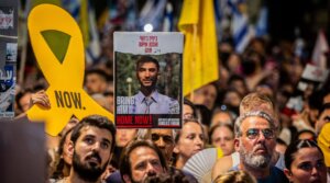 Protesters hold up signs and a placard of Bipin Joshi, who was then held hostage by Hamas, in a demonstration in Tel Aviv, Aug. 17, 2025.