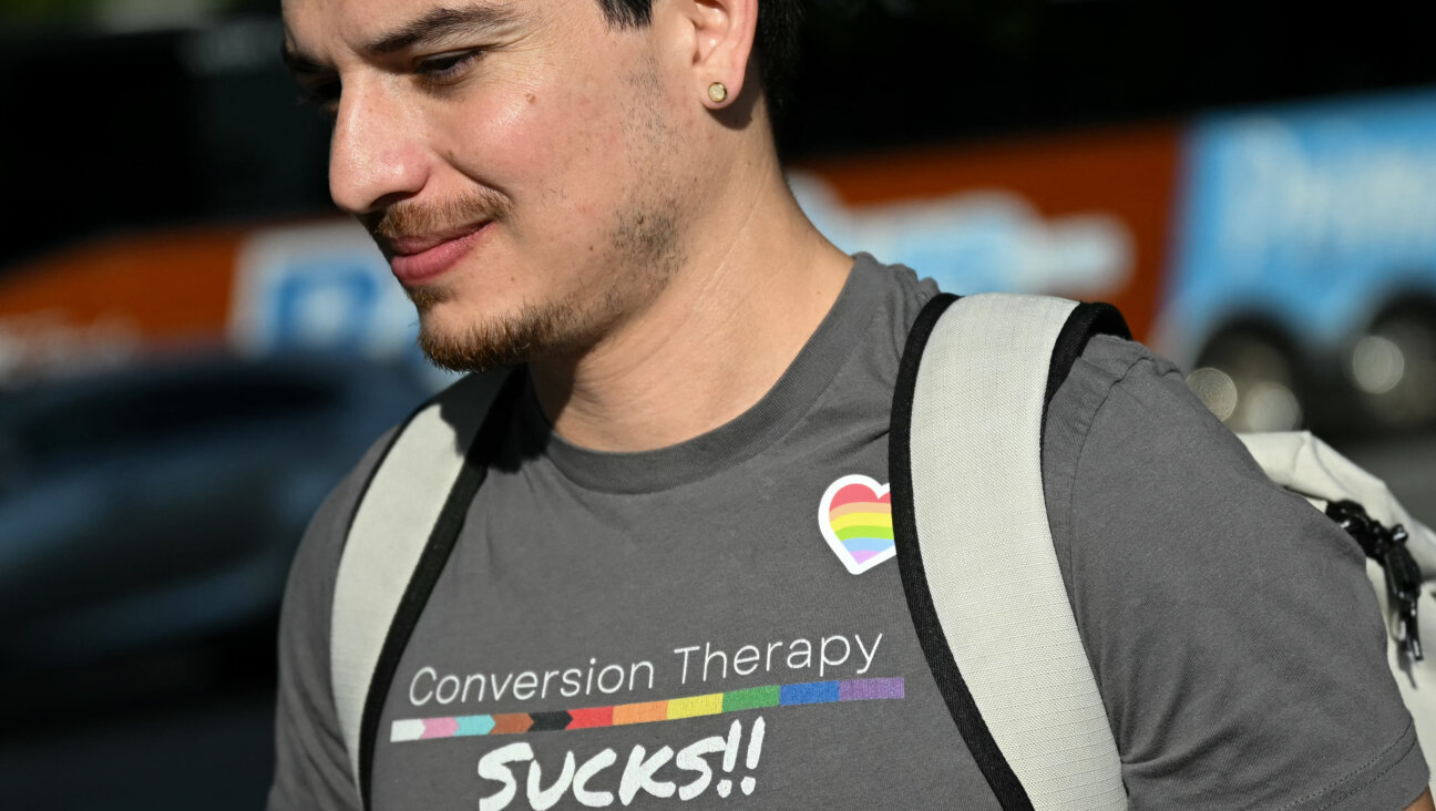A man wears a shirt reading "conversion therapy sucks" outside the US Supreme Court as the Court hears oral arguements in Chiles v. Salazar, a landmark case on conversion therapy, Oct. 7.