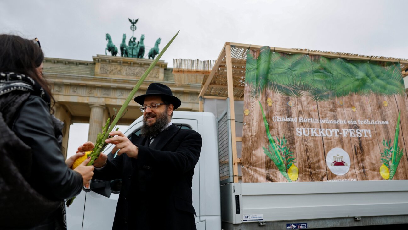A Chabad rabbi offer prayers in front of a mobile "Sukkah" to celebrate the Jewish holiday of Sukkot at Brandenburg Gate in Berlin.
