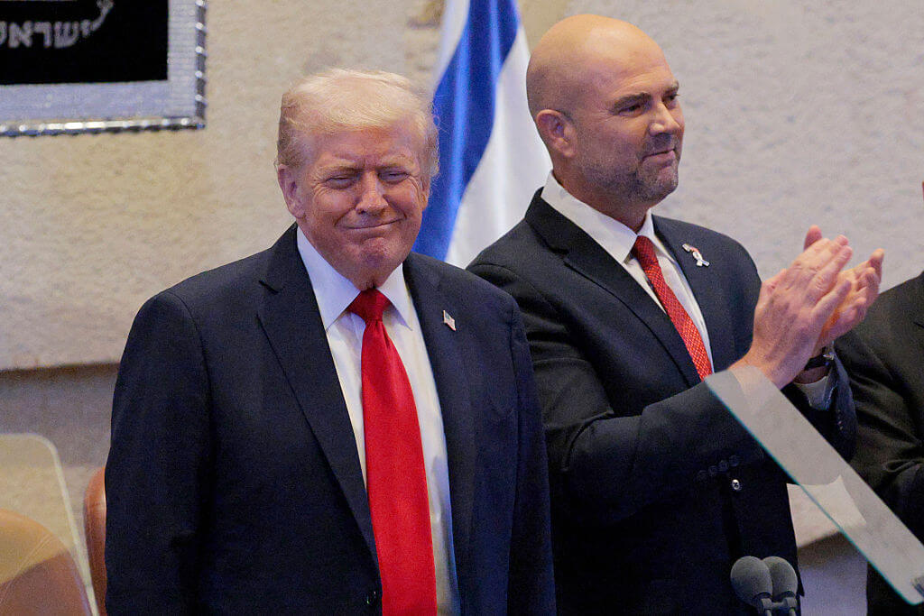 U.S. President Donald Trump arrives to address the Knesset, Israel’s parliament, with Amir Ohana, Speaker of the Israeli Knesset, on October 13, 2025 in Jerusalem. President Trump is visiting the country hours after Hamas released some of the remaining Israeli hostages captured on Oct. 7, 2023, part of a US-brokered ceasefire deal to end the war in the Gaza Strip. 