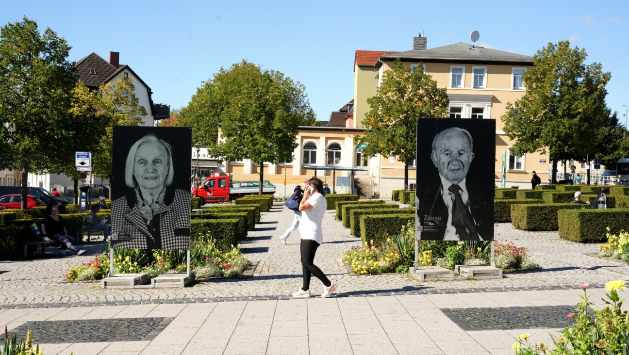 Photos of survivors from Buchenwald by photographer Thomas Müller stand in the square outside of Weimar’s central train station in the public art project “Die Zeugen”.