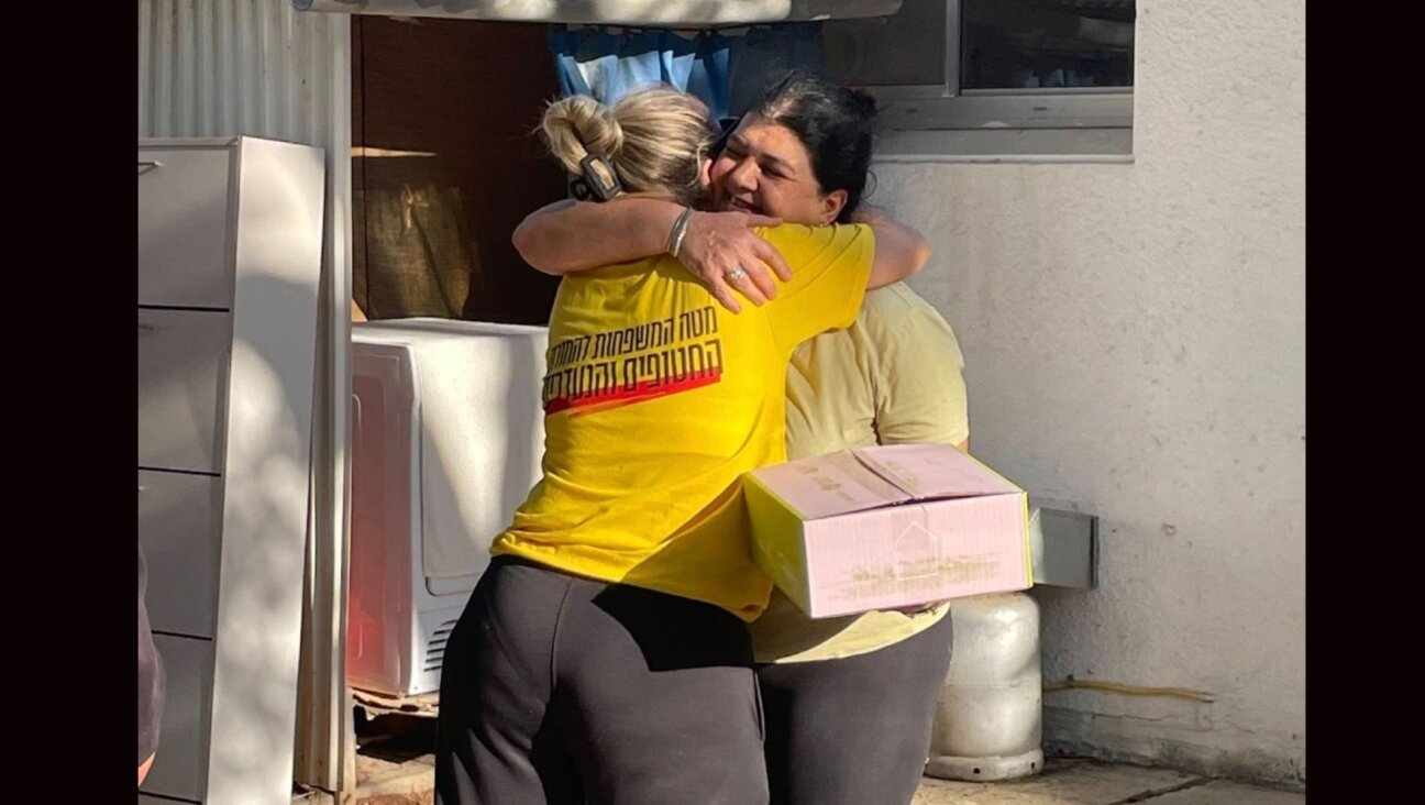 A kibbutz member receives her homecoming kit from the Kibbutz Movement Rehabilitation Fund. 