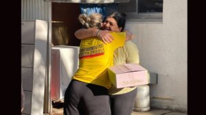 A kibbutz member receives her homecoming kit from the Kibbutz Movement Rehabilitation Fund. 