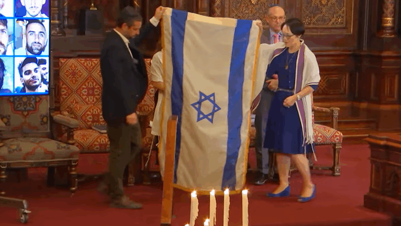 Rabbi Angela Buchdahl and Dagan Shimoni folded the Israeli flag that has been displayed on Central Synagogue's bimah since the attacks of Oct. 7, 2023.