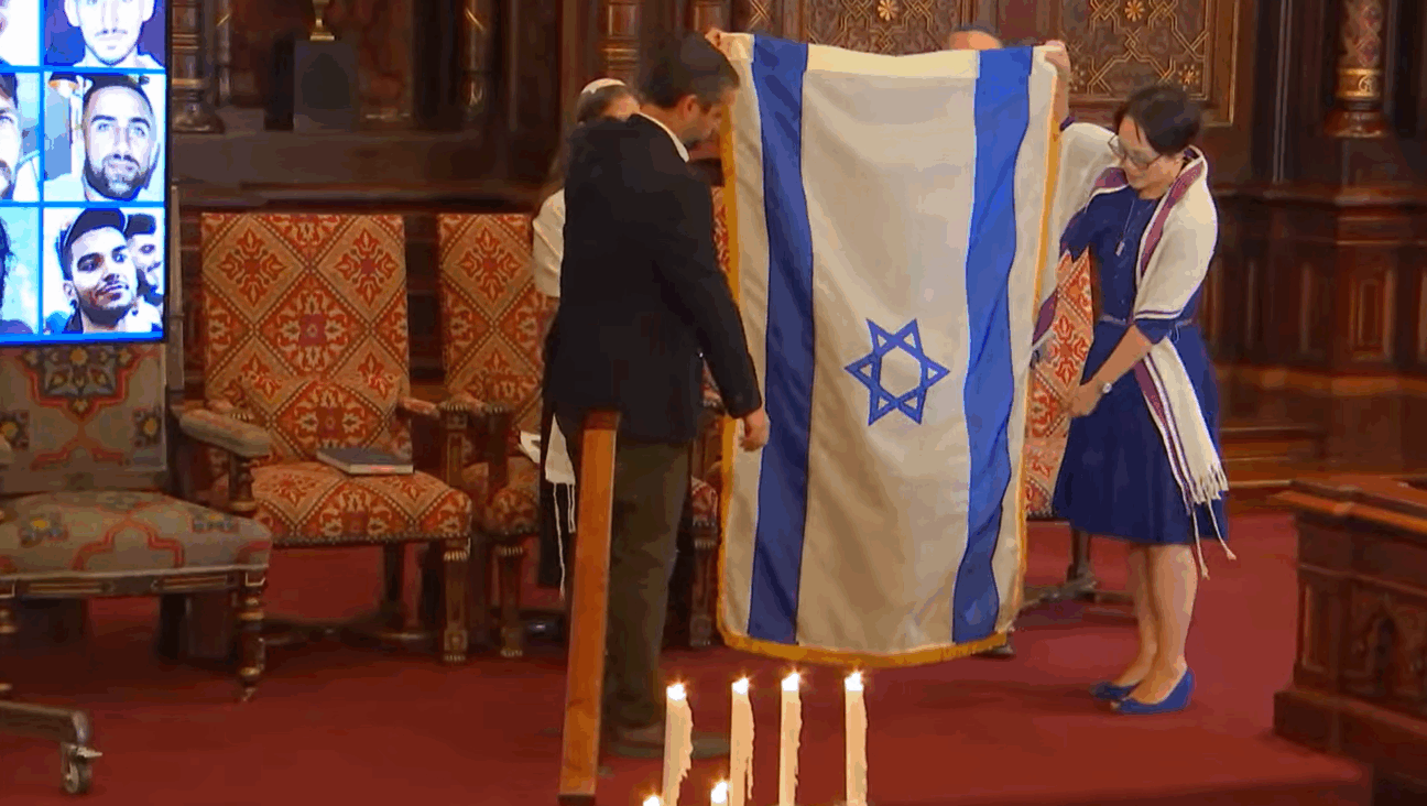 Rabbi Angela Buchdahl and Dagan Shimoni folded the Israeli flag that has been displayed on Central Synagogue's bimah since the attacks of Oct. 7, 2023.