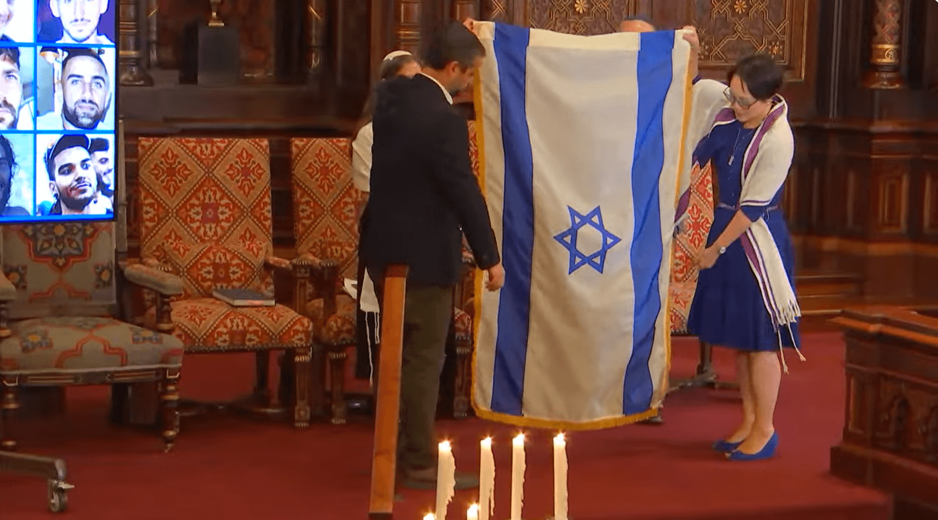 Rabbi Angela Buchdahl and Dagan Shimoni folded the Israeli flag that has been displayed on Central Synagogue's bimah since the attacks of Oct. 7, 2023.