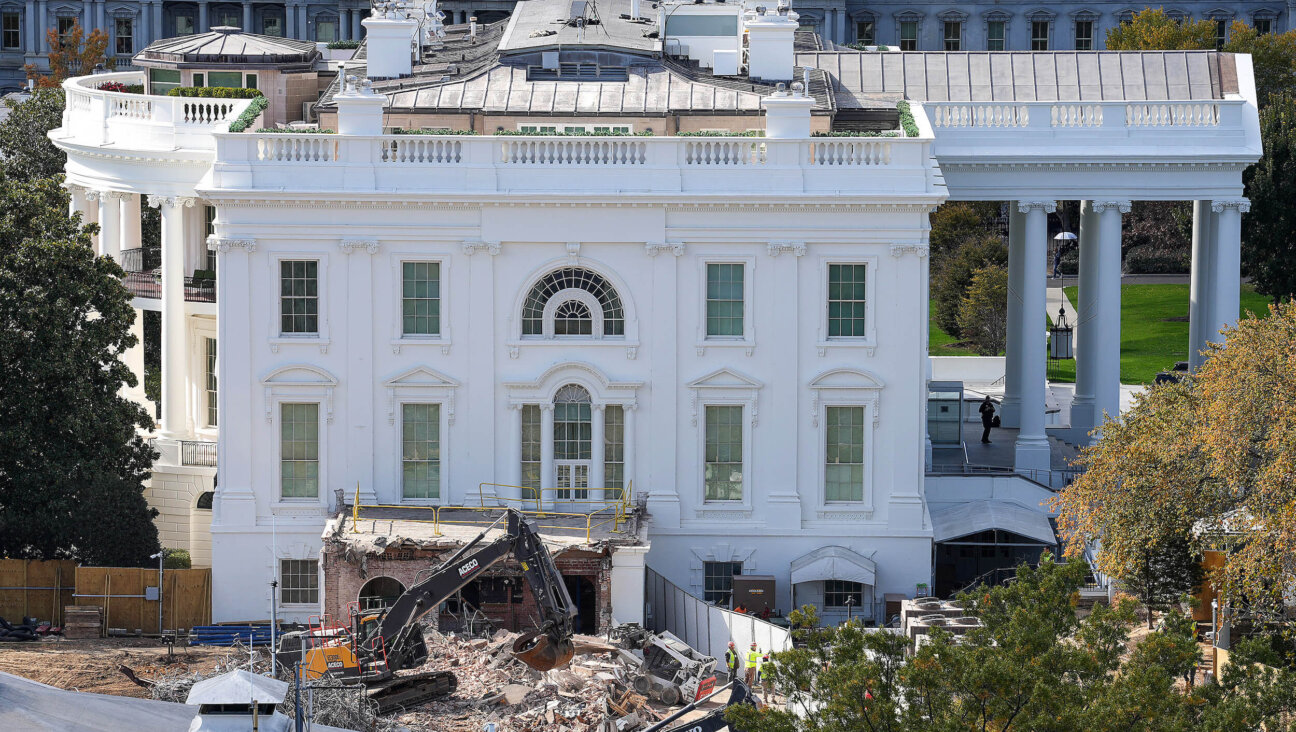 An excavator works to clear rubble on Oct. 23 after the East Wing of the White House was demolished.