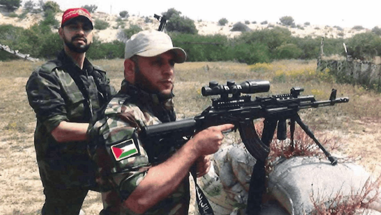 Mahmoud Amin Ya-qub Al-Muhtadi (left) allegedly conducts firearm training for the National Resistance Brigades. 
