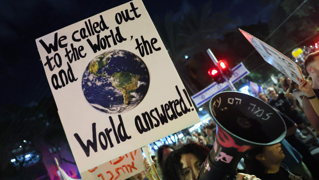 Demonstrators lift placards during an anti-government protest calling for a ceasefire and the return of Israelis held hostage in Gaza, in front of the Likud party building in Tel Aviv on Sept. 30.