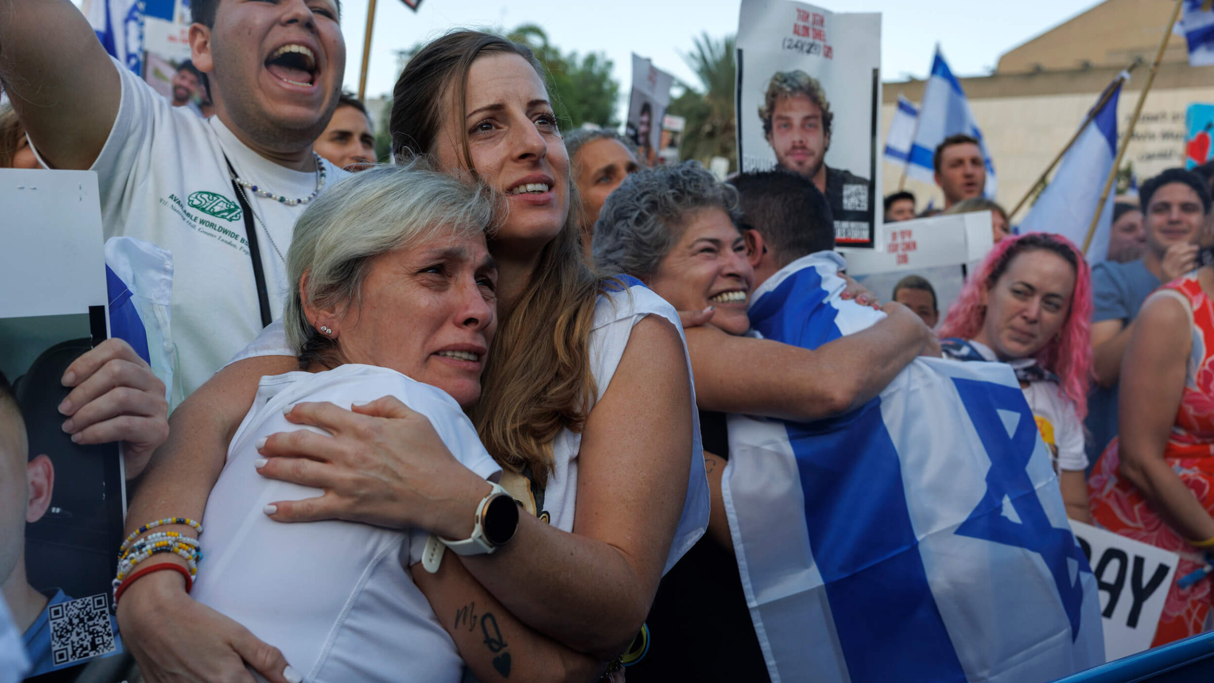 Israelis react as they watch the release of Israeli hostages by Hamas during a live broadcast in Tel Aviv, Israel, on Oct. 13.