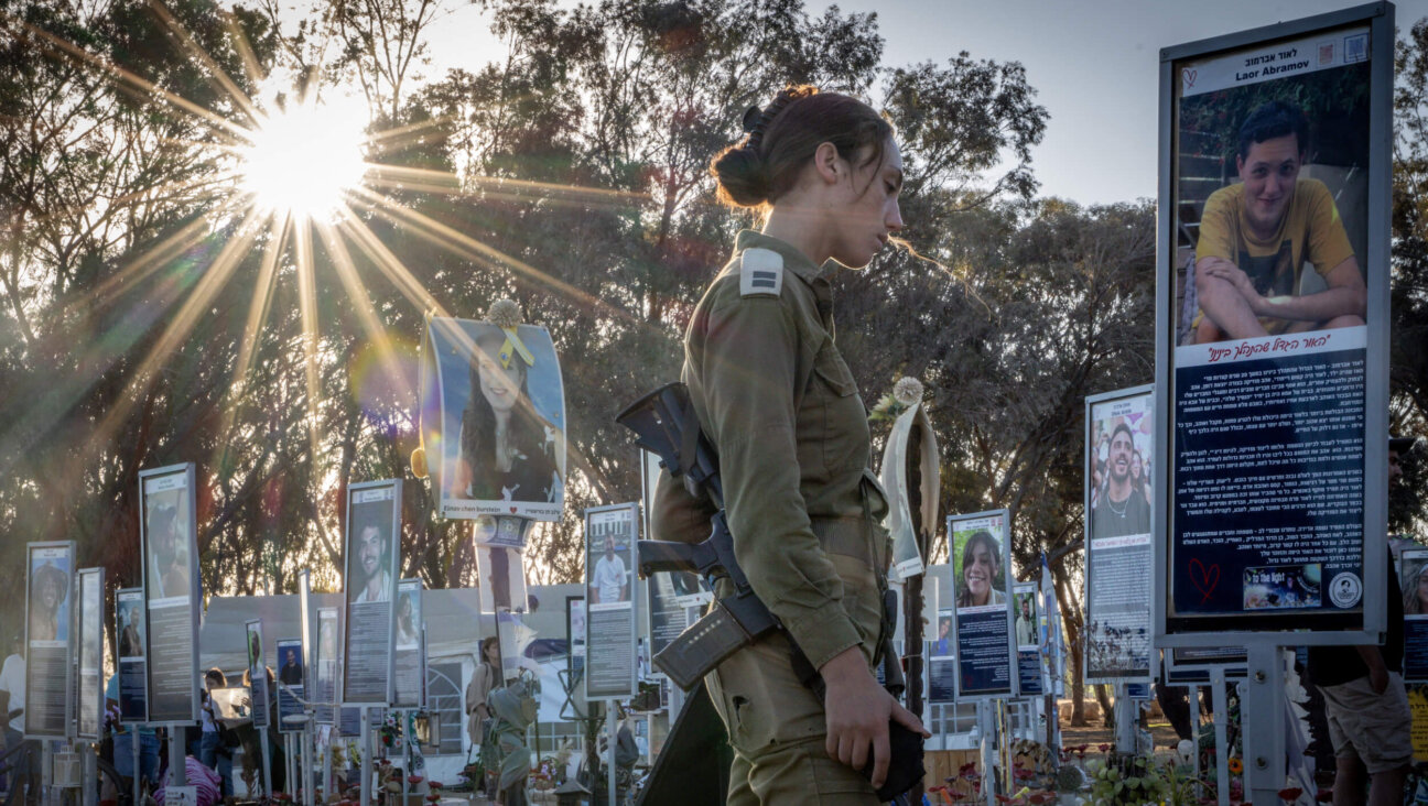 Alma Shahaf, an Israeli soldier, mourns at a memorial for a friend killed at the Nova festival on the 2nd anniversary of the Oct. 7 attacks.