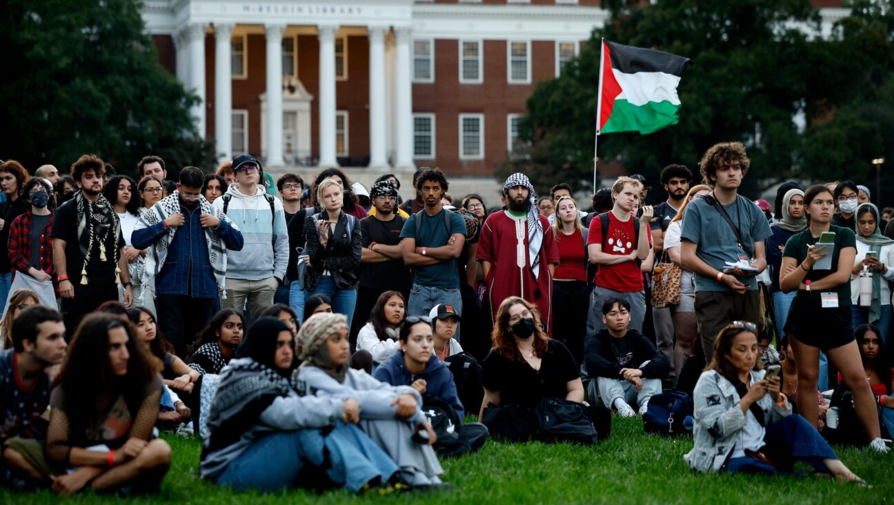 Attendees listen as names of Palestinian infants killed in the war in Gaza are read aloud during a vigil organized by the Students for Justice in Palestine at the University of Maryland campus on October 07, 2024 in College Park, Maryland. 
