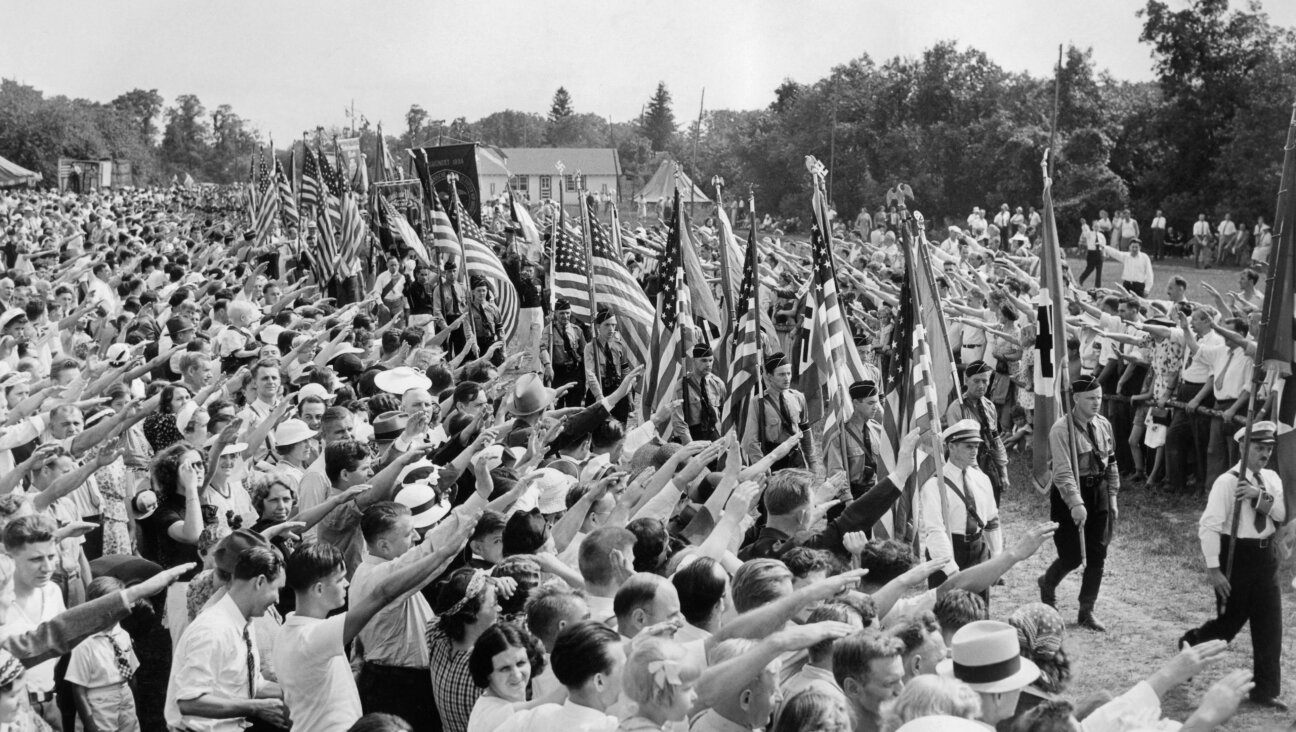Hundreds of thousands of German-Americans show their affinity for Hitler by raising their hands in a Nazi salute during an annual 'German Day' at Camp Siegfried in Long Island, 1937.