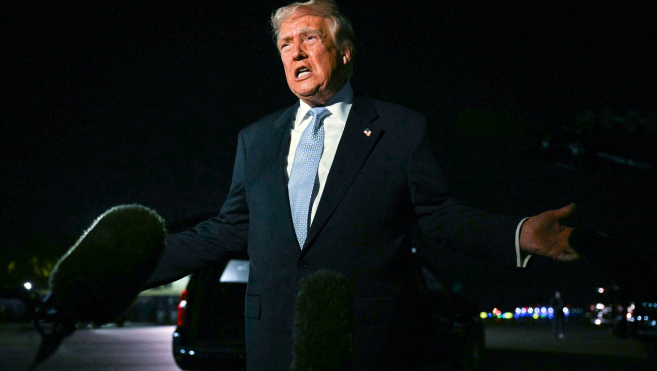 President Donald Trump speaks with reporters before boarding Air Force One as he departs West Palm Beach, Florida, Sunday night to return to the White House on November 16.