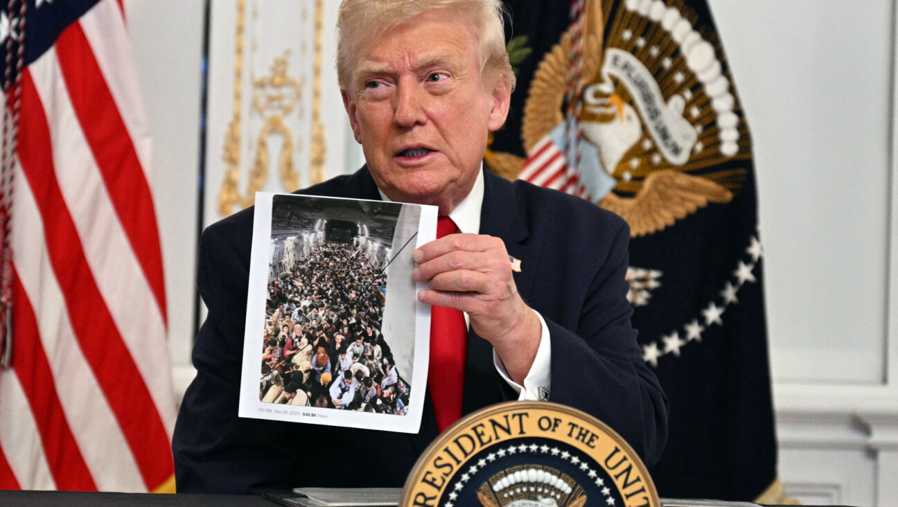 Donald Trump shows a printed photo during a call with service members on Thanksgiving.