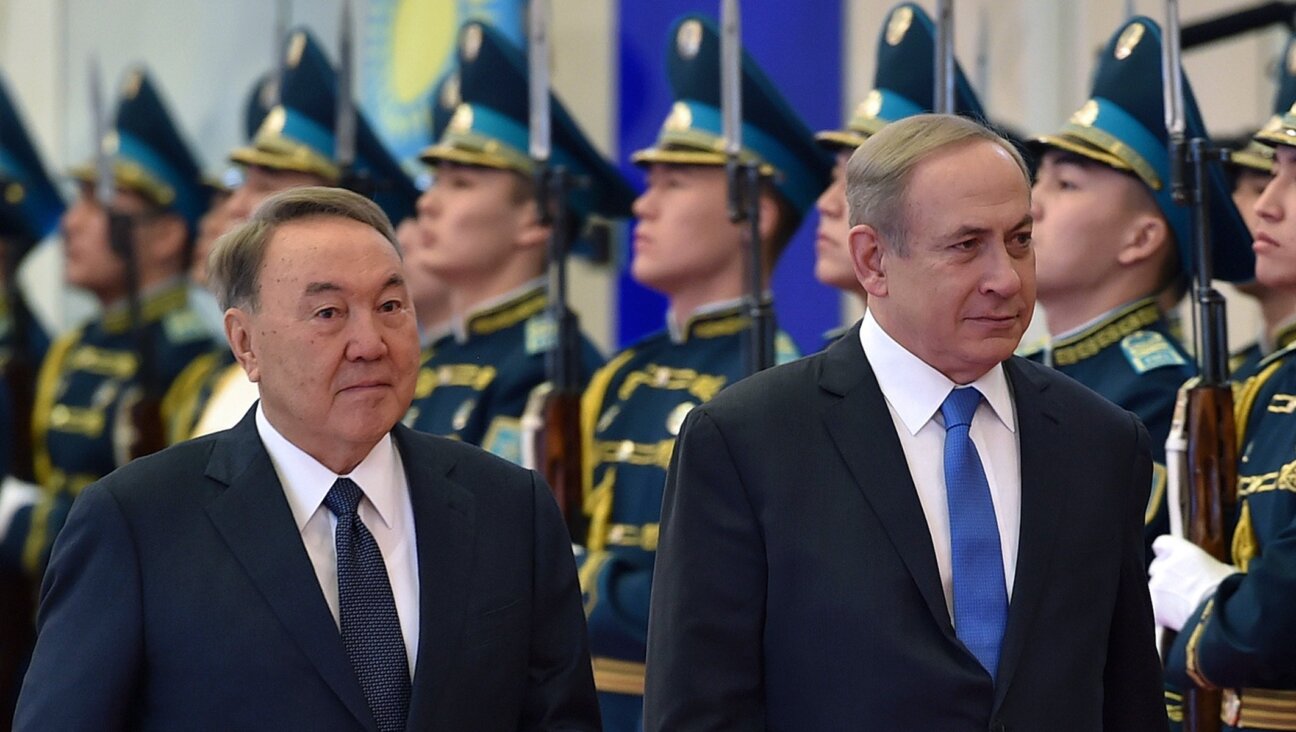 Then-Kazakh President Nursultan Nazarbayev, left, and Israeli Prime Minister Benjamin Netanyahu inspect honor guards during their meeting in Astana, Kazakhstan on Dec. 14, 2016. 