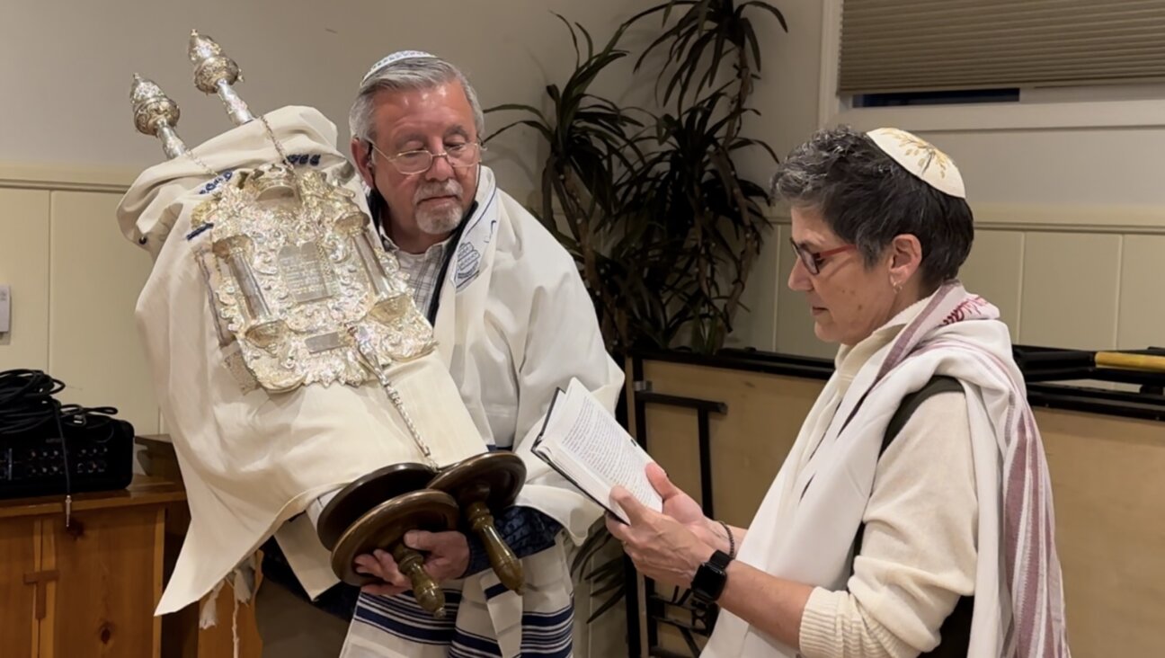 Joe Martin holds the Torah for the first time during his welcoming ceremony, where he was introduced to the congregation as having completed his conversion.