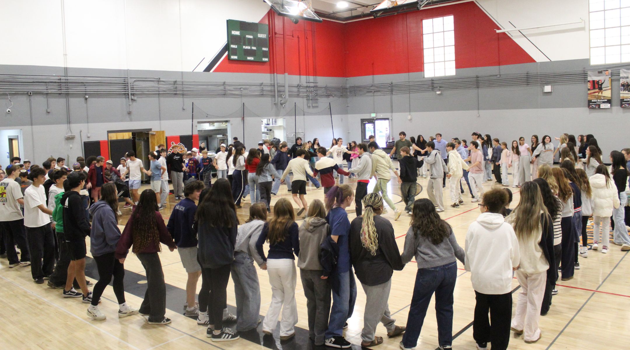 Students gather in the gym for a Rosh Chodesh celebration at Denver Jewish Day School, an event that now fills the space as enrollment continues to rise.