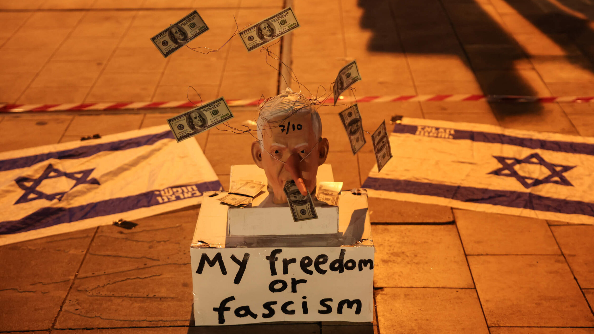 A mask mocking Israeli Prime Minister Benjamin Netanyahu is placed on the street during a demonstration in support of establishing a state commission of inquiry into Hamas' Oct. 7, 2023, attack.