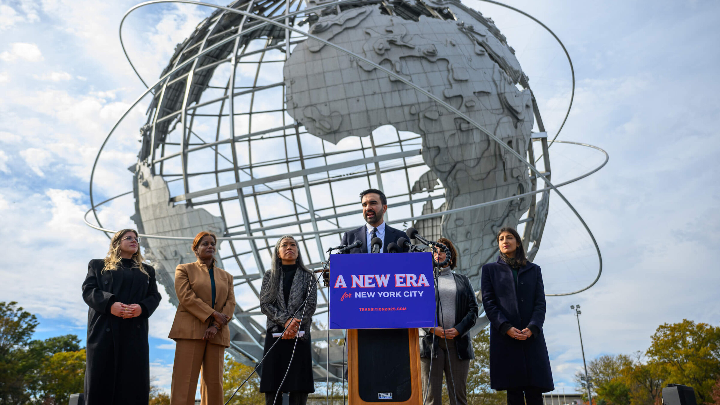 Mayor-elect of New York City Zohran Mamdani (C) stands alongside members of his transition team as he speaks during a press conference at the Unisphere in Flushing Meadows Corona Park on Nov. 5.