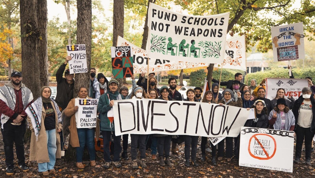 Demonstrators with Brak the Bonds North Carolina holding signs demanding divestment outside of the State Treasurer’s Office on Oct. 29, 2025. 