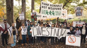 Demonstrators with Brak the Bonds North Carolina holding signs demanding divestment outside of the State Treasurer’s Office on Oct. 29, 2025. 