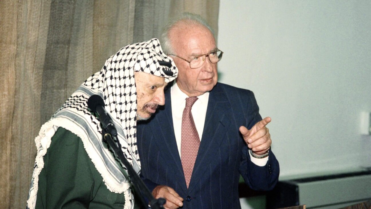 Israeli Prime Minister Yitzhak Rabin (R) speaks to PLO Chairman Yasser Arafat (L) on Sept. 25, 1994.