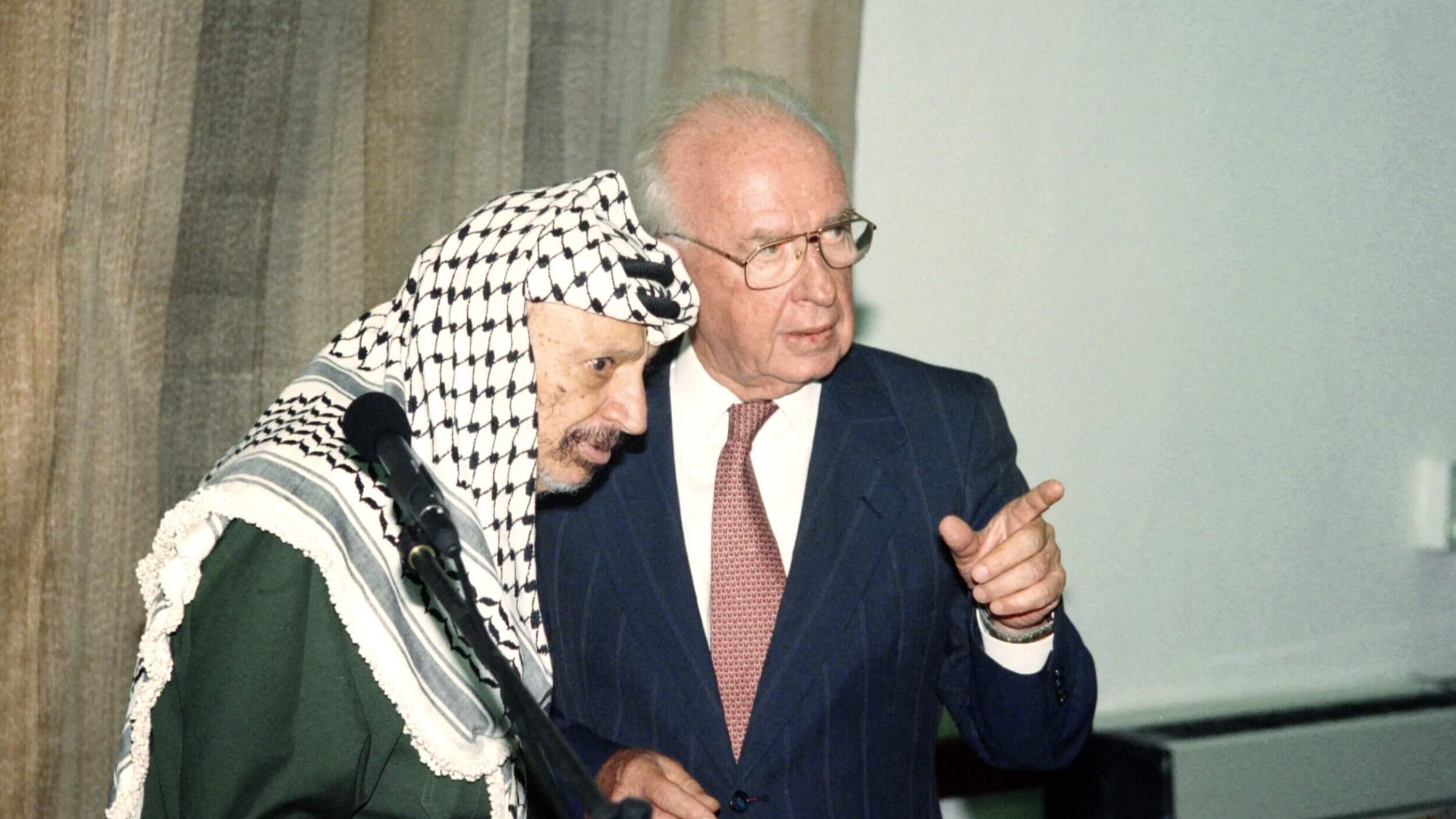 Israeli Prime Minister Yitzhak Rabin, right, speaks to PLO Chairman Yasser Arafat, left, on Sept. 25, 1994.