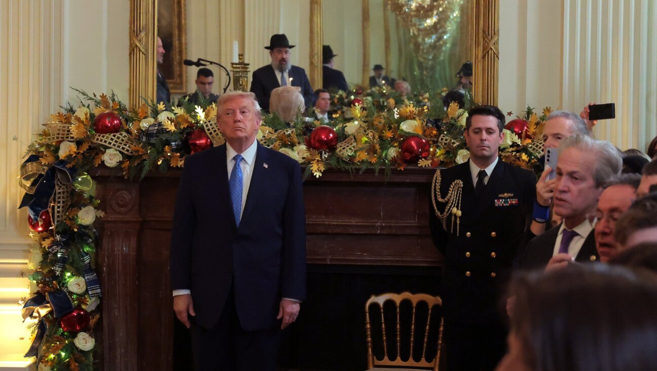 President Donald Trump (L) looks on during a Hanukkah Reception in the East Room of the White House on December 16, 2025 in Washington, DC. Trump hosted attendees to celebrate the holiday and the lighting of the menorah on the third night of Hanukkah. 